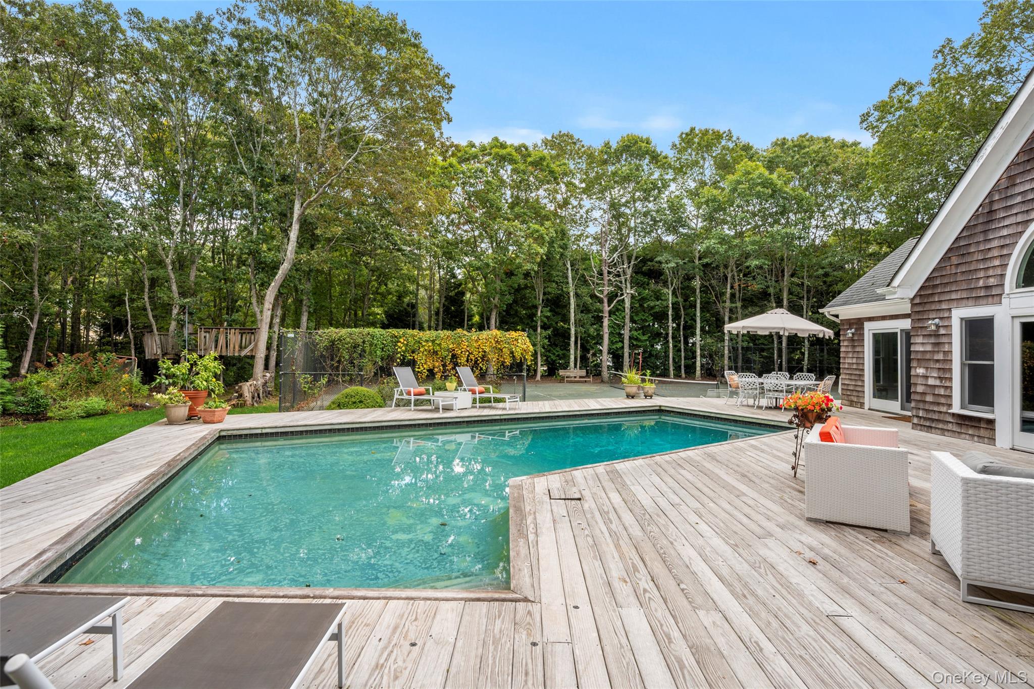38 Pheasant Run Quogue, NY 11959 - Photo 32 of 35 a view of a swimming pool with a patio and a yard
