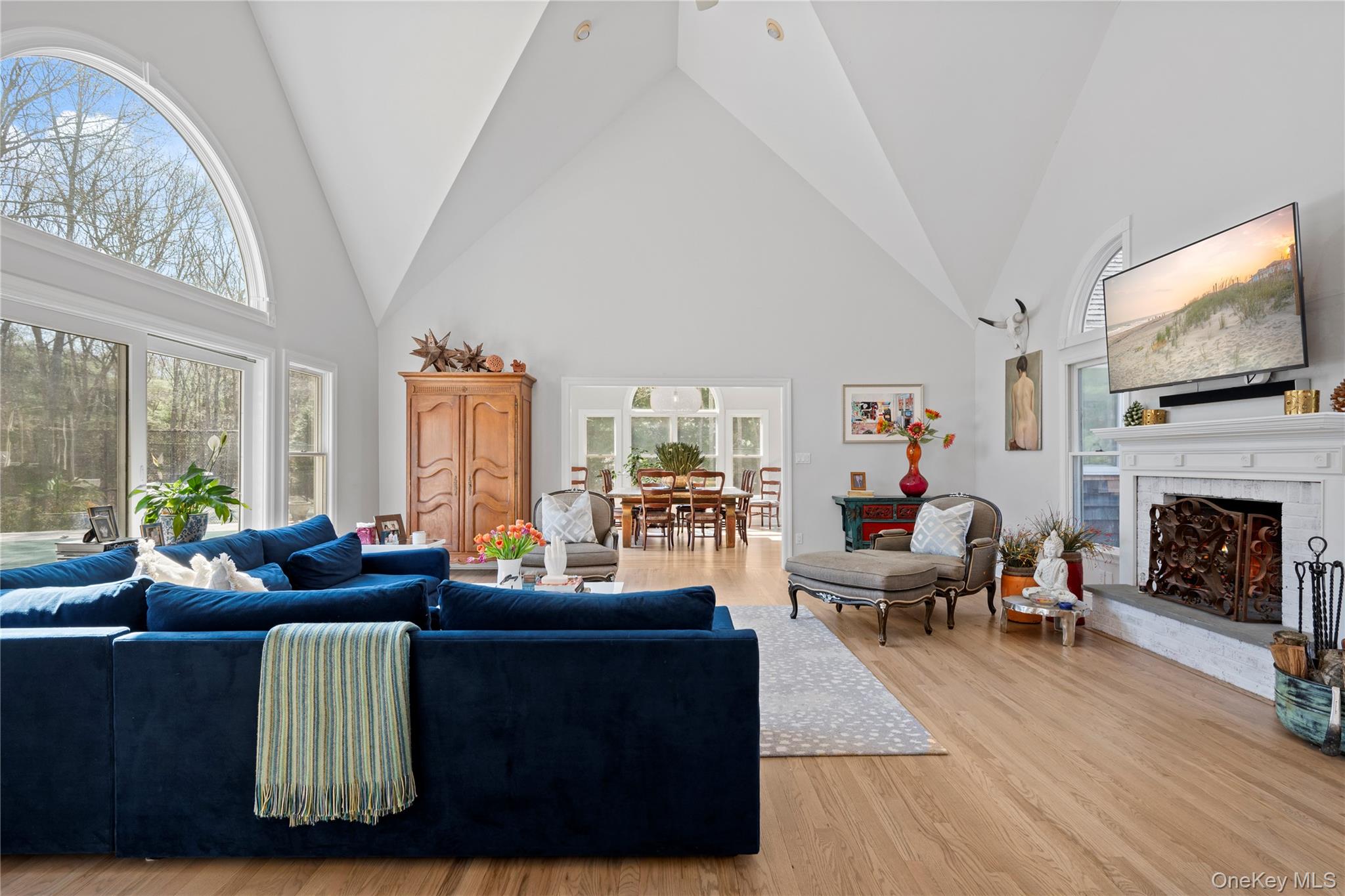 38 Pheasant Run Quogue, NY 11959 - Photo 8 of 35 a living room with furniture a fireplace and a flat screen tv