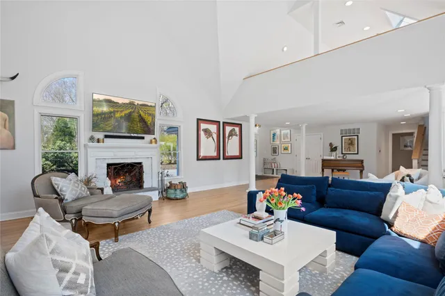 a living room with furniture a fireplace and a flat screen tv