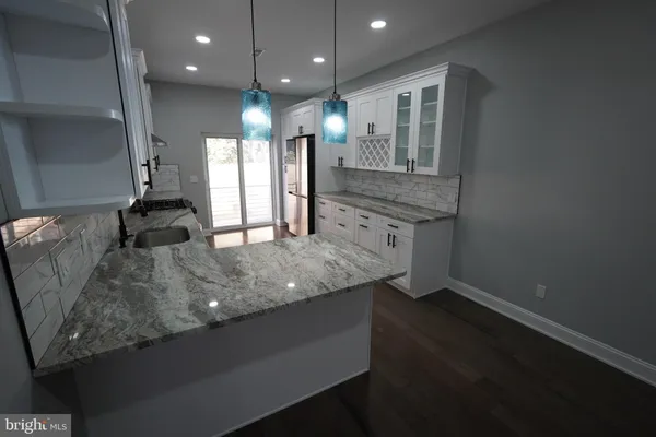 a kitchen with a sink stainless steel appliances and cabinets