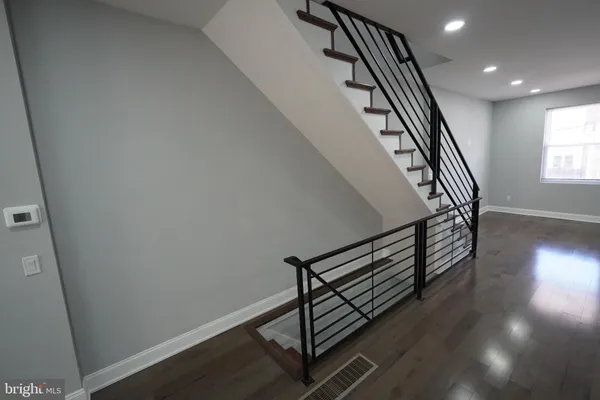 a view of entryway with wooden floor and stairs