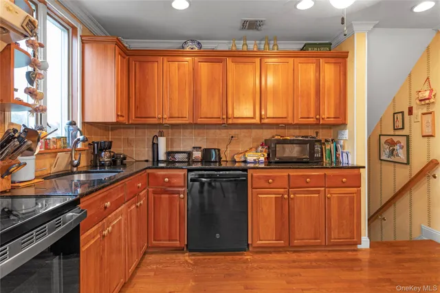 a kitchen with stainless steel appliances granite countertop a stove a sink and a refrigerator