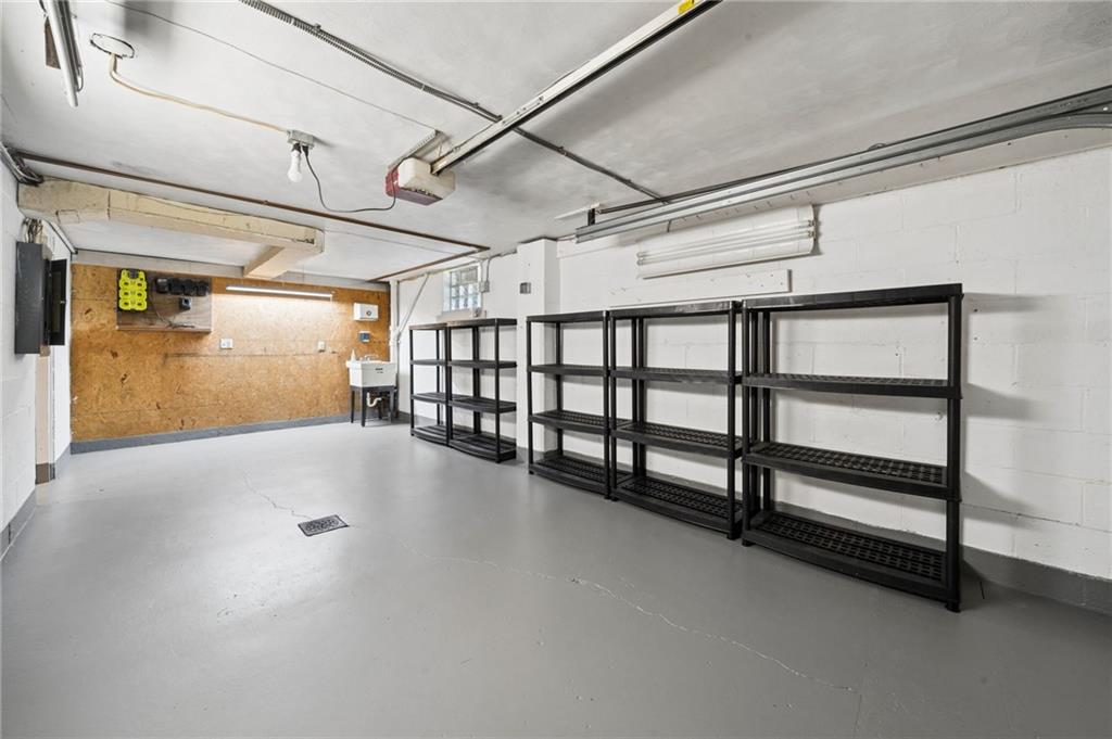 711 Jane Street Pittsburgh, PA 15239 - Photo 21 of 27 Spacious garage with sleek flooring and built-in storage racks for ultimate organization.