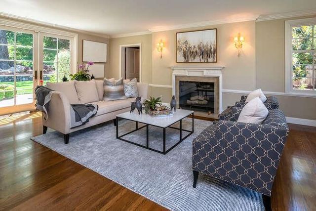 a living room with furniture and a fireplace