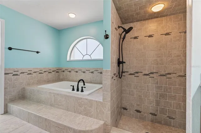 a bathroom with a sink a glass door shower and a mirror