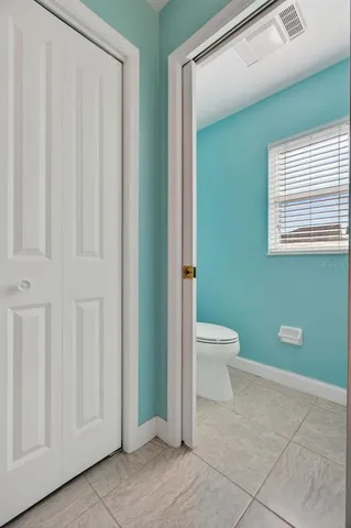 a bathroom with a toilet a sink and a window