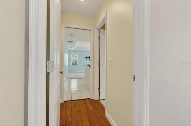 a view of a hallway with wooden floor