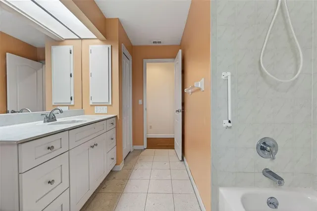 a bathroom with a tub sink and mirror