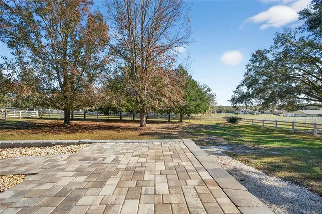 a kitchen with a refrigerator and white cabinets