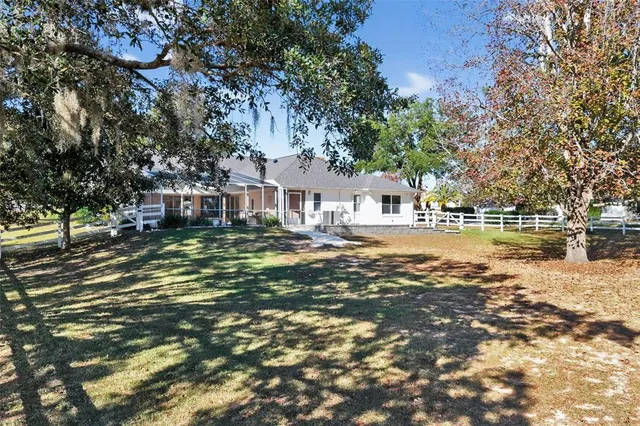 a view of swimming pool with sitting area and garden