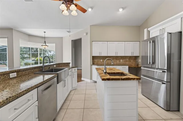a kitchen with a refrigerator and a sink