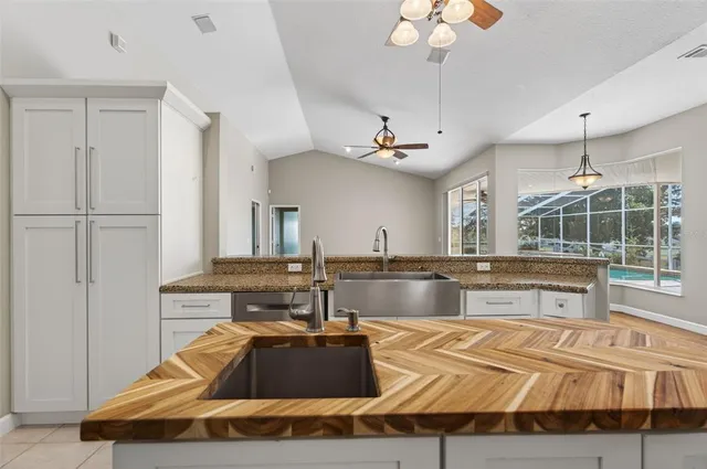 a living room with kitchen island furniture and a chandelier