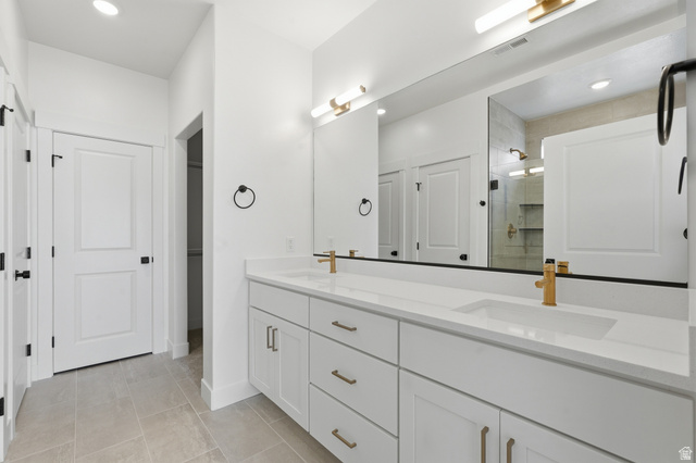 401 West 3085 South, Unit 329 Nibley, UT 84321 - Photo 31 of 34 Bathroom with double vanity, a stall shower, recessed lighting, a closet, and light tile patterned floors