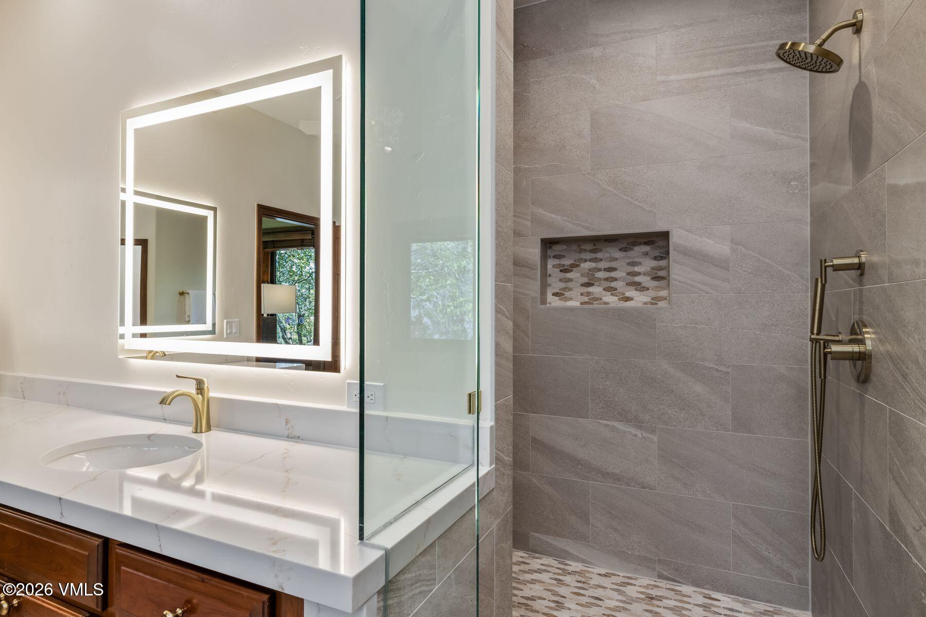 167 Saddle Ridge Edwards, CO 81632 - Photo 18 of 41 a bathroom with a granite countertop sink a mirror and shower