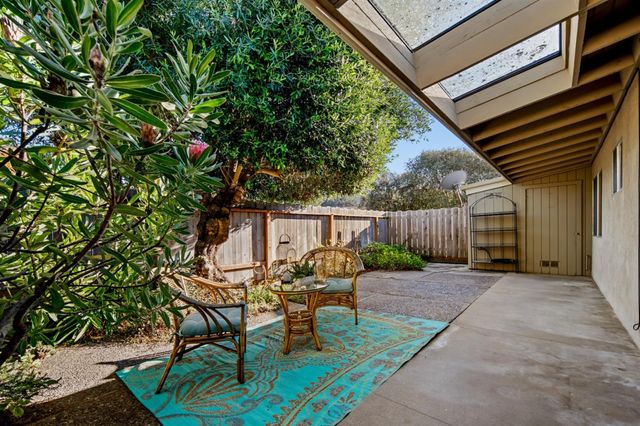 a backyard of a house with table and chairs