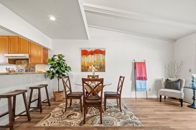 a dining room with furniture and wooden floor