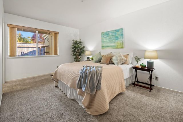 a bed room with a bed and paintings on the wall