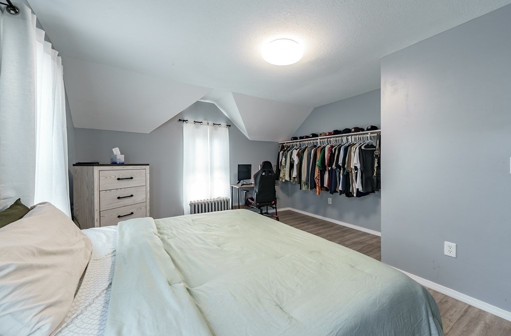 26 Beech Street Springfield, MA 01105 - Photo 12 of 24 a bedroom with a large bed and a tv