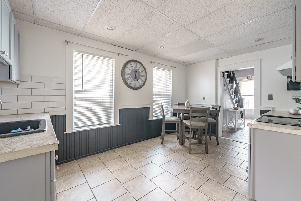 26 Beech Street Springfield, MA 01105 - Photo 7 of 24 a kitchen with a stove a table and chairs