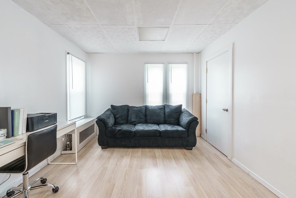 26 Beech Street Springfield, MA 01105 - Photo 8 of 24 a living room with furniture and a wooden floor