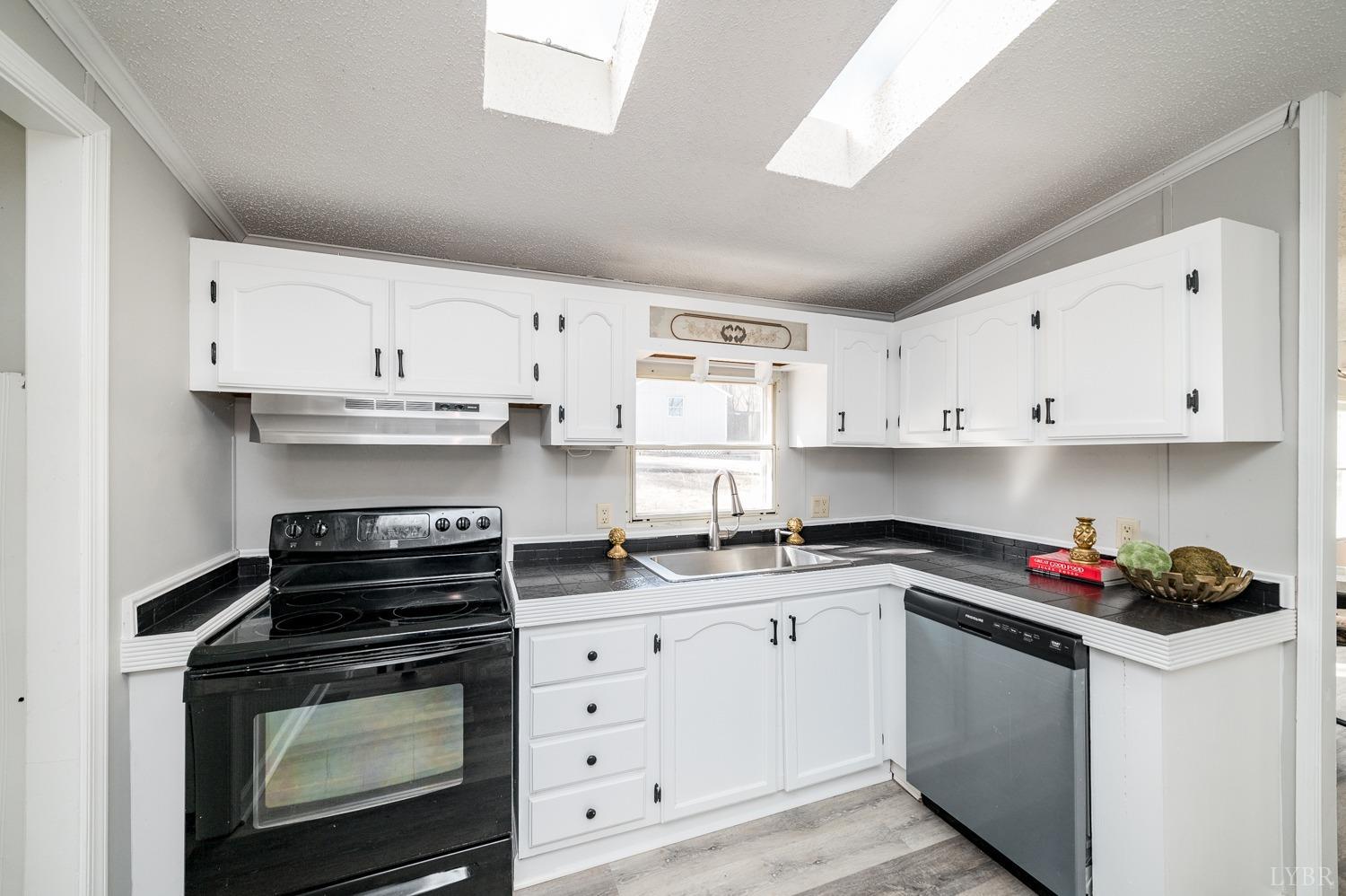 1274 English Tavern Road Rustburg, VA 24588 - Photo 15 of 43 a kitchen with stainless steel appliances granite countertop a sink stove and cabinets