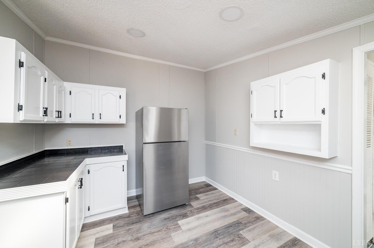 1274 English Tavern Road Rustburg, VA 24588 - Photo 17 of 43 a kitchen with a refrigerator sink and cabinets
