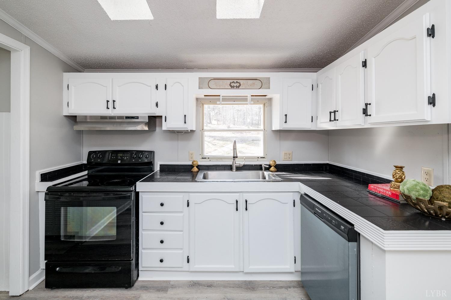 1274 English Tavern Road Rustburg, VA 24588 - Photo 19 of 43 a kitchen with white cabinets and appliances