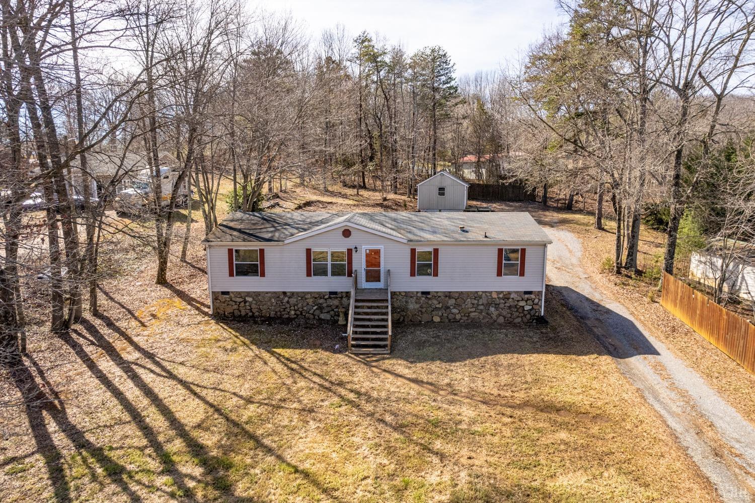 1274 English Tavern Road Rustburg, VA 24588 - Photo 2 of 43 a view of a white house with a yard covered in snow