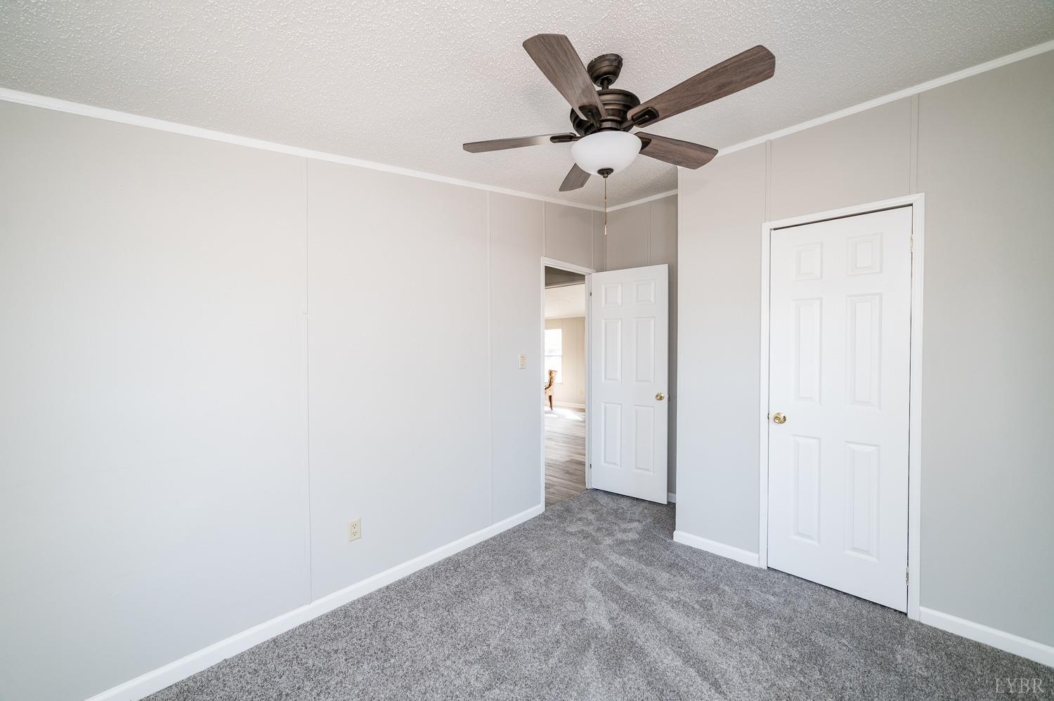 1274 English Tavern Road Rustburg, VA 24588 - Photo 21 of 43 an empty room with a ceiling fan and a ceiling fan