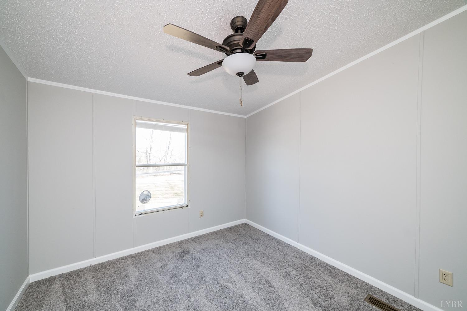 1274 English Tavern Road Rustburg, VA 24588 - Photo 23 of 43 an empty room with a window and a fan