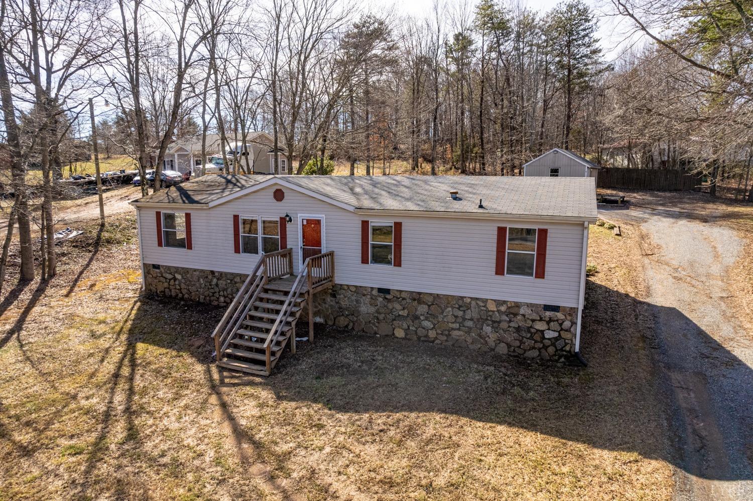 1274 English Tavern Road Rustburg, VA 24588 - Photo 3 of 43 a view of a house with a yard covered with snow in the background