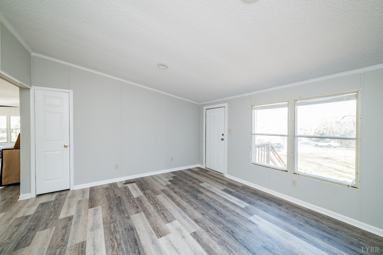 1274 English Tavern Road Rustburg, VA 24588 - Photo 6 of 43 a view of an empty room with wooden floor and a window