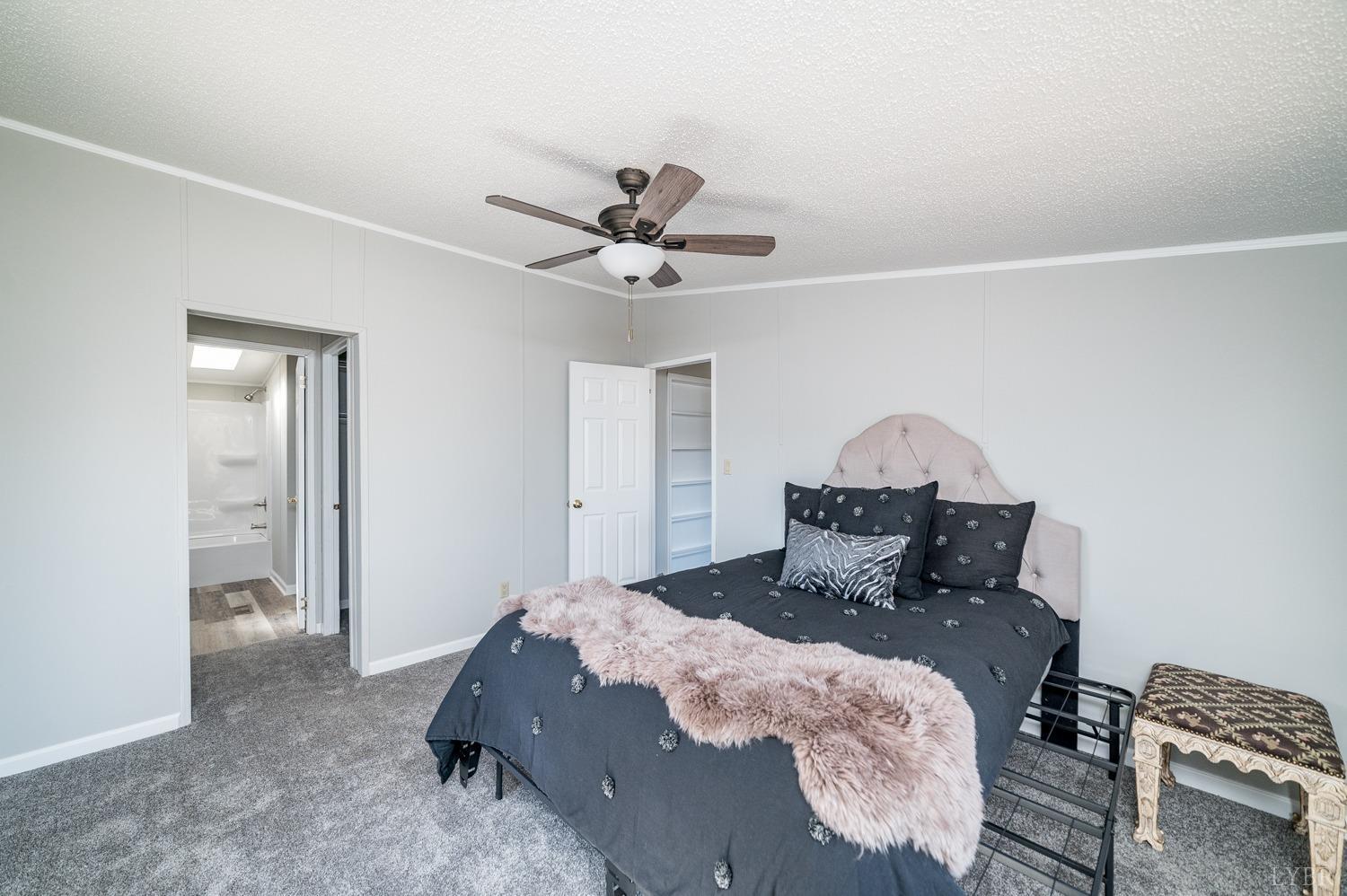 1274 English Tavern Road Rustburg, VA 24588 - Photo 8 of 43 a bed room with a bed and a chandelier