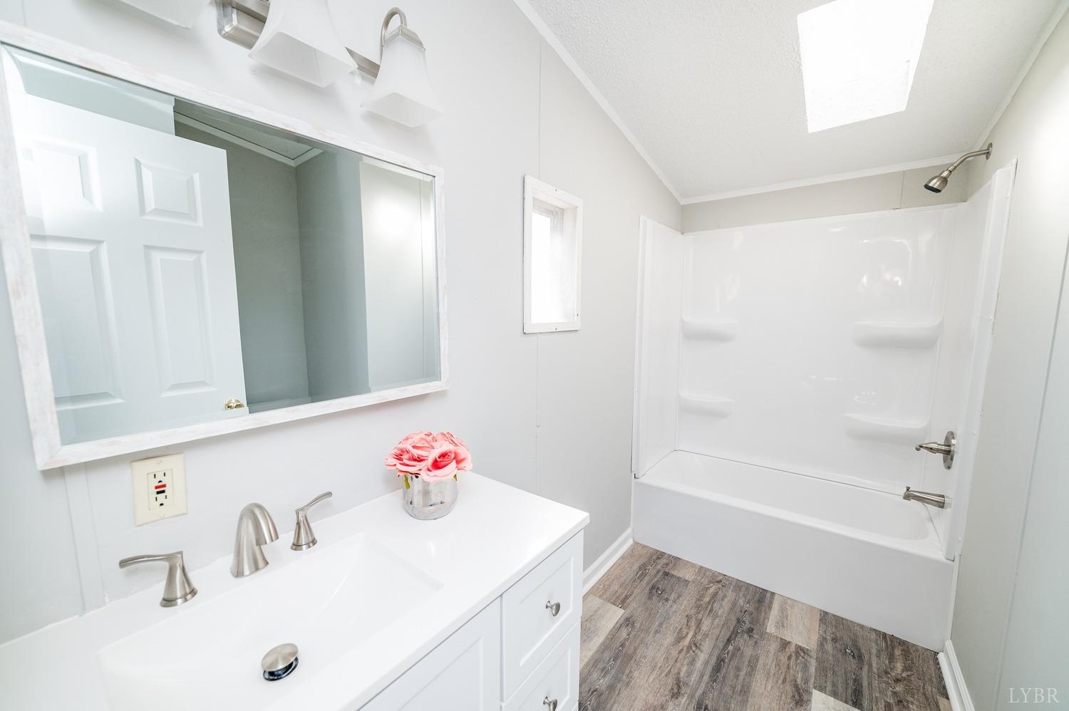 1274 English Tavern Road Rustburg, VA 24588 - Photo 10 of 43 a bathroom with a sink vanity tub and shower