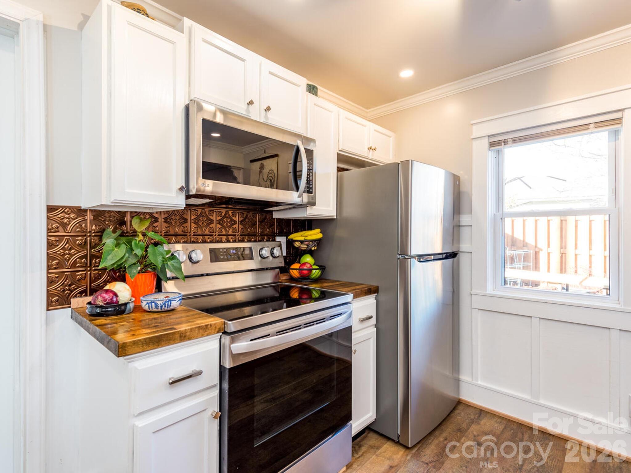 29 White Oak Road Arden, NC 28704 - Photo 12 of 42 a kitchen with stainless steel appliances granite countertop a refrigerator stove and sink