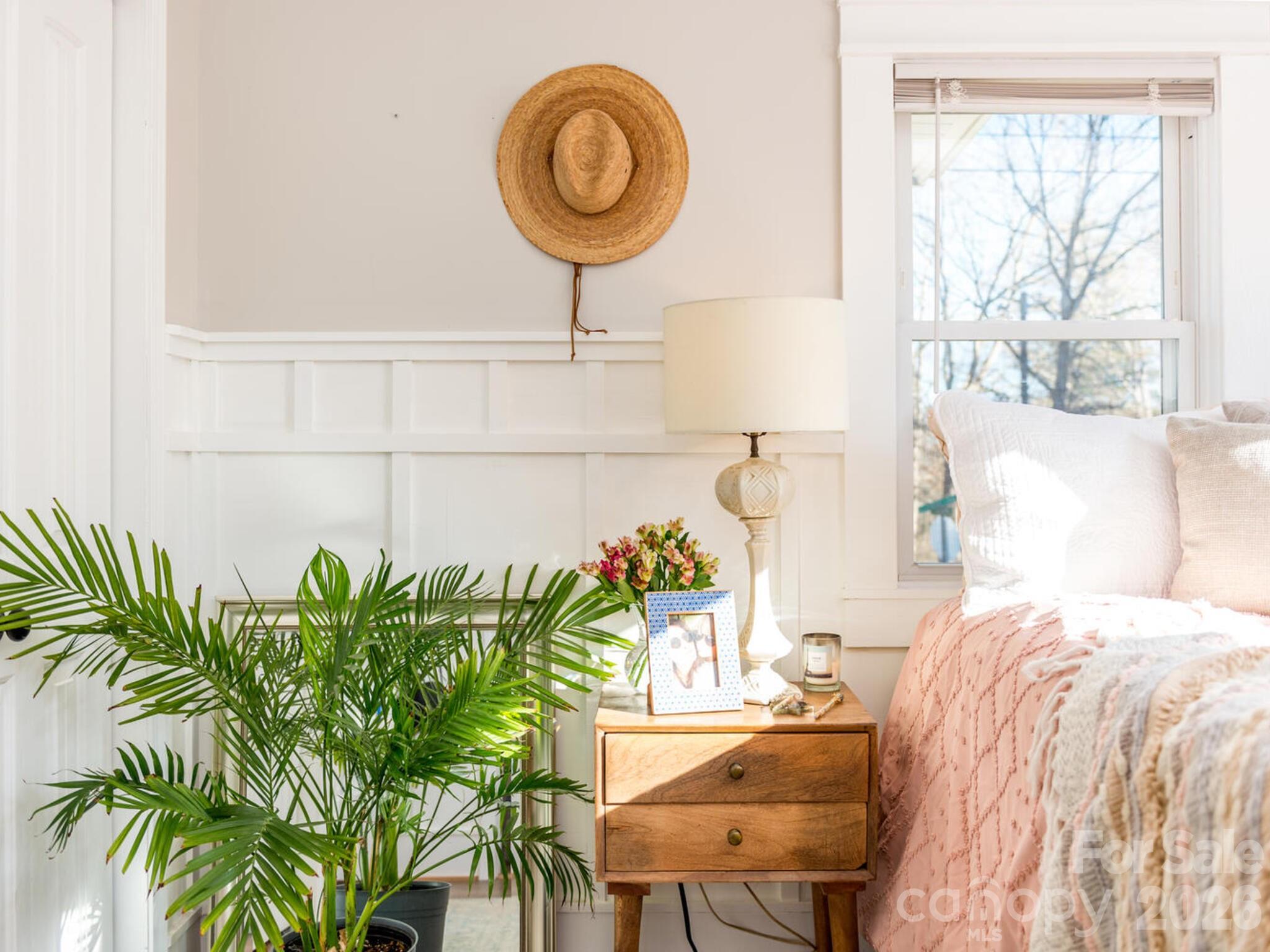 29 White Oak Road Arden, NC 28704 - Photo 15 of 42 a bedroom with a bed and a potted plant