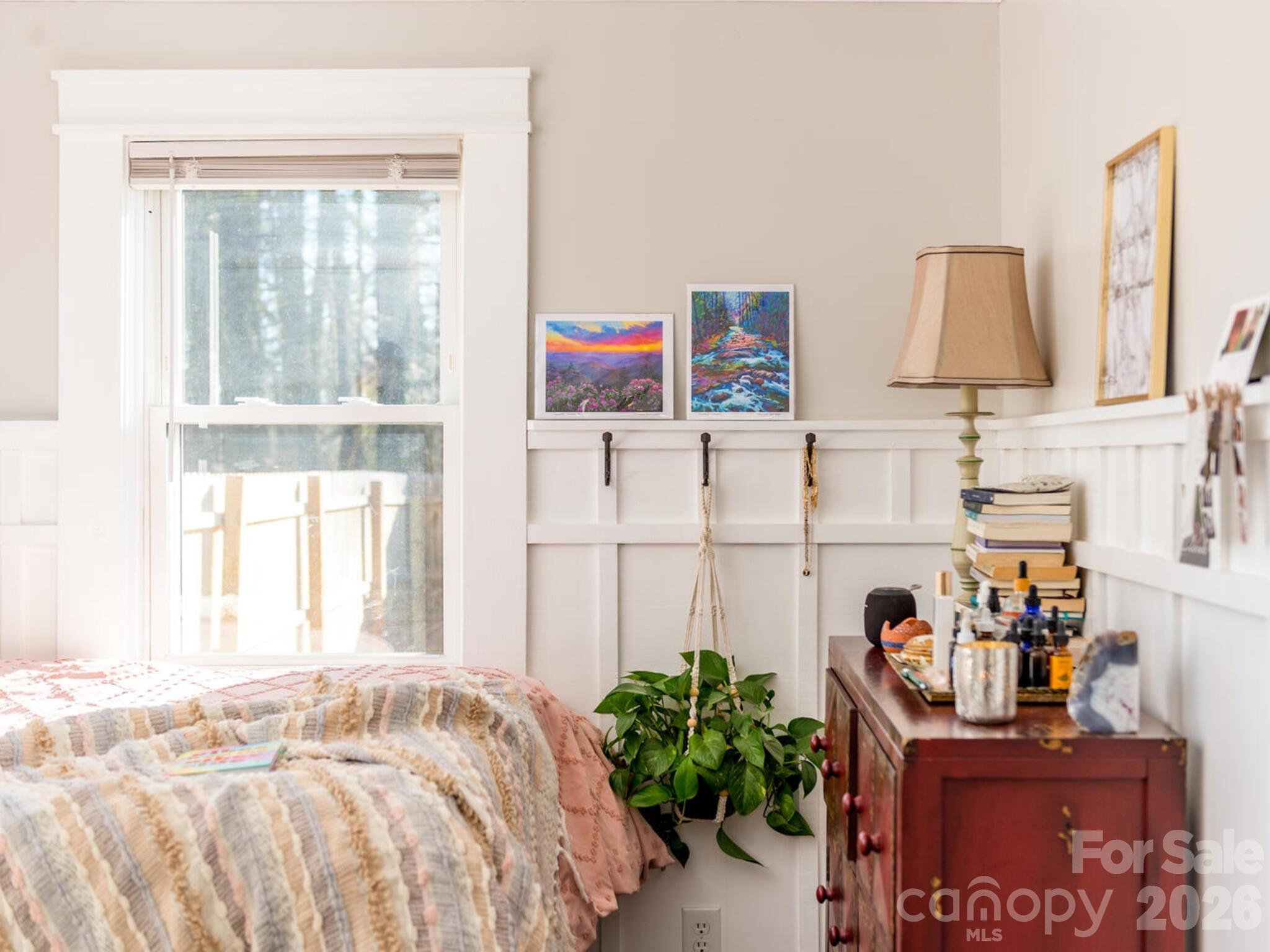 29 White Oak Road Arden, NC 28704 - Photo 17 of 42 a bed room with a bed and a potted plant