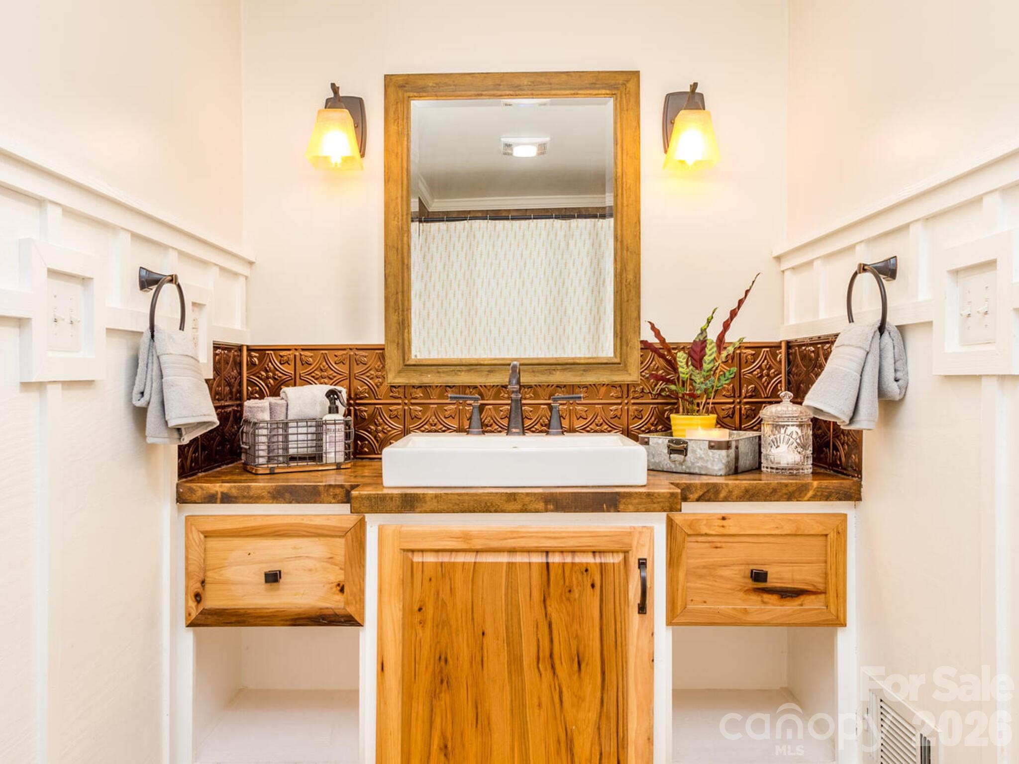 29 White Oak Road Arden, NC 28704 - Photo 23 of 42 a bathroom with a sink and a mirror