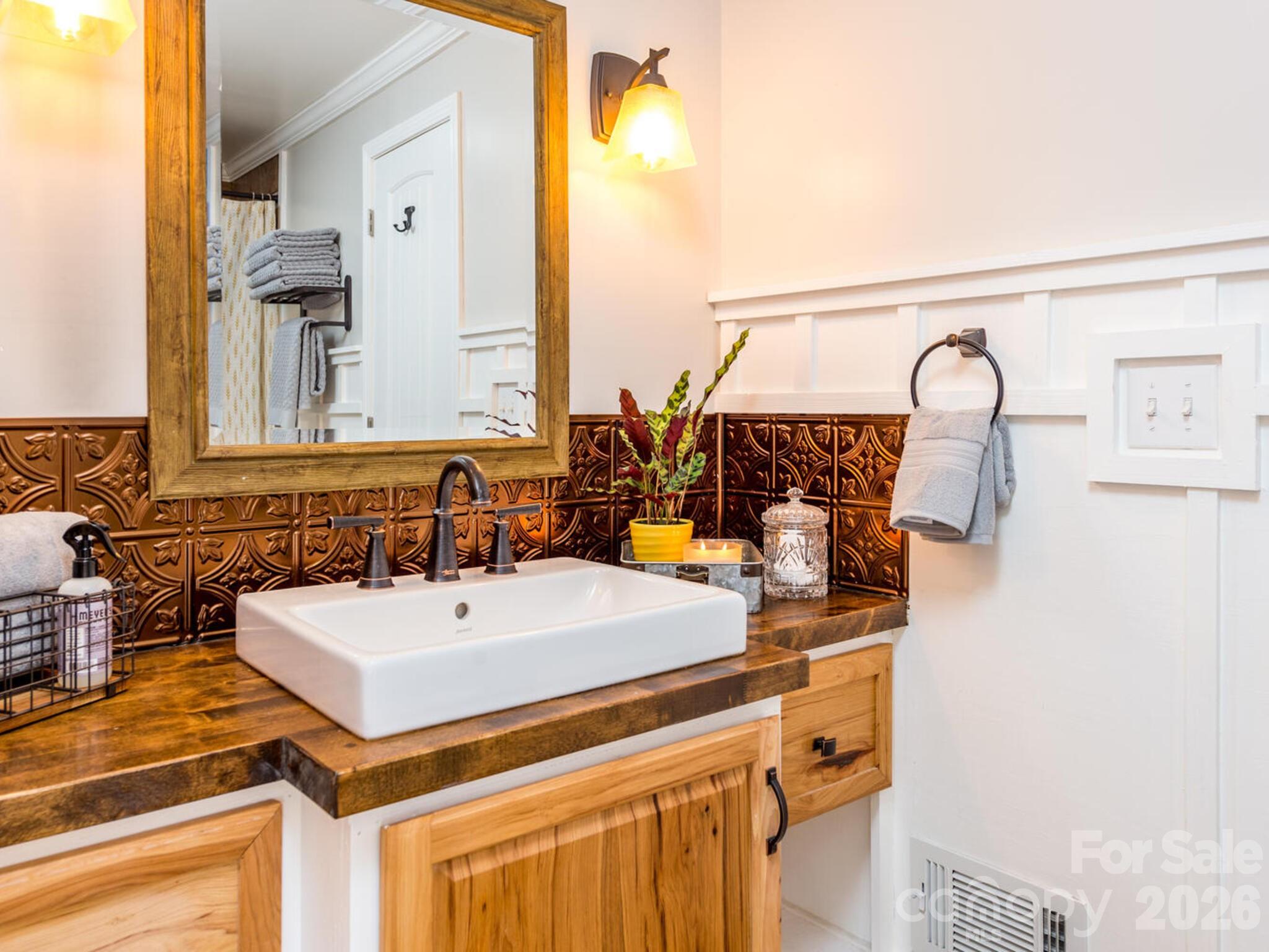 29 White Oak Road Arden, NC 28704 - Photo 24 of 42 a bathroom with a sink and a mirror