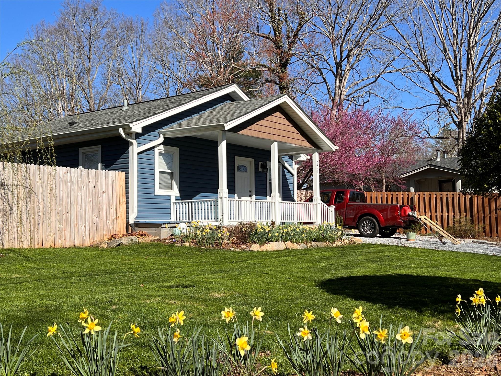 29 White Oak Road Arden, NC 28704 - Photo 33 of 42 a front view of a house with a garden and trees