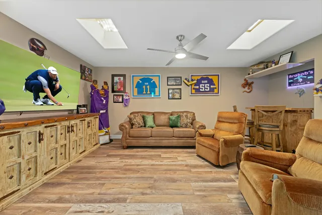 a bathroom with a sink a toilet a mirror and shower