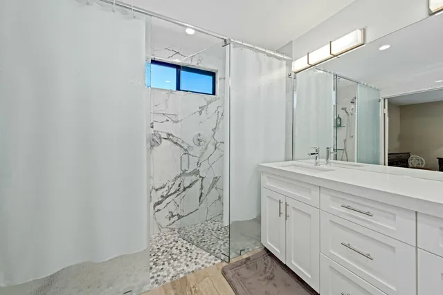 a bedroom with a bed and furniture with a flat tv screen