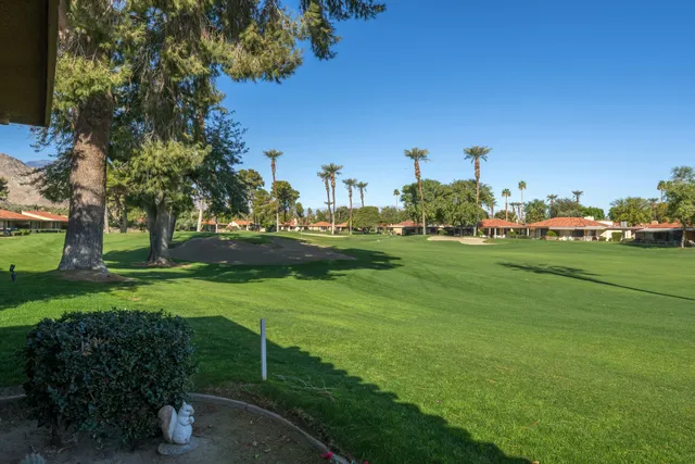 a view of a house with backyard sitting area and garden
