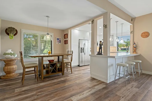 a view of a dining room with furniture window and wooden floor