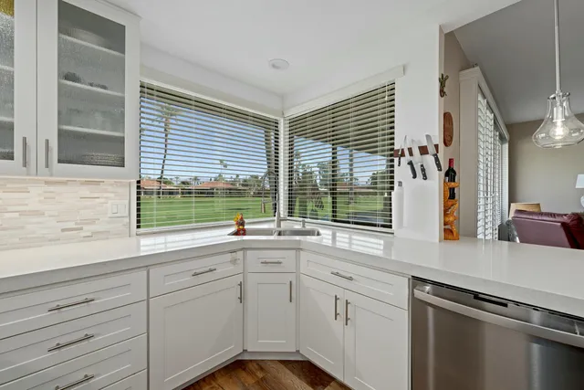 a kitchen with a sink and large window