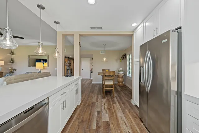 a kitchen with stainless steel appliances a refrigerator and a sink