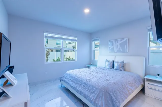 a bedroom with a bed and a window