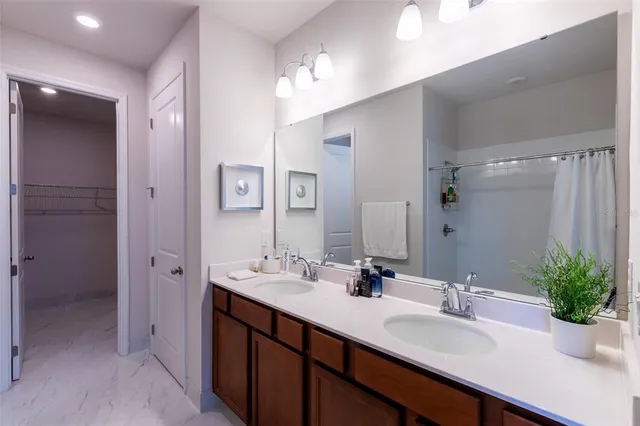 a bathroom with a sink double vanity and a mirror