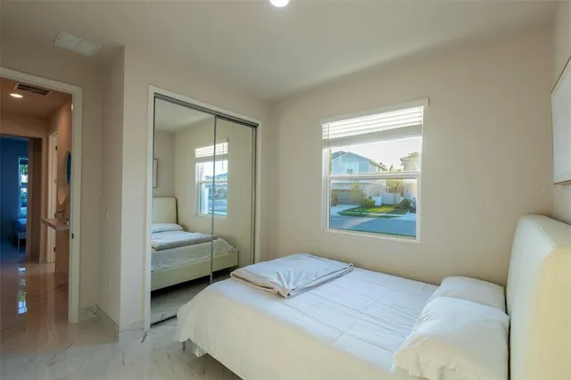 a bedroom with a bed and a window