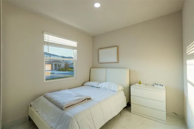 a bedroom with a bed and a window